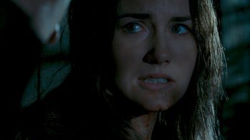 Movie still from “Slither” (2006), directed by James Gunn – A person with blood on their face; Close Up shot, Over the shoulder angle