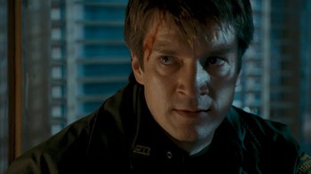 Movie still from “Slither” (2006), directed by James Gunn – A person wearing a black jacket; Close Up shot, Over the shoulder angle
