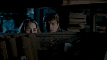 Movie still from “Slither” (2006), directed by James Gunn – A man and a woman looking at each other through a fence; Close Up shot, Over the shoulder angle