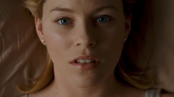 Movie still from “Slither” (2006), directed by James Gunn – A woman's face with blue eyes; Close Up shot, Overhead angle