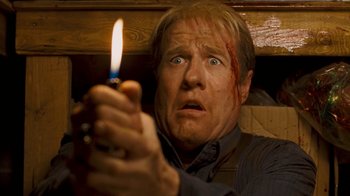 Movie still from “Slither” (2006), directed by James Gunn – A person holding a lit candle; Close Up shot, Low angle
