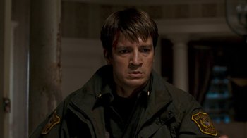 Movie still from “Slither” (2006), directed by James Gunn – A person wearing a uniform; Close Up shot, Over the shoulder angle