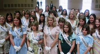 Movie still from “Smile” (1975), directed by Michael Ritchie – A group of women in formal wear posing for a picture; Wide shot, Low angle