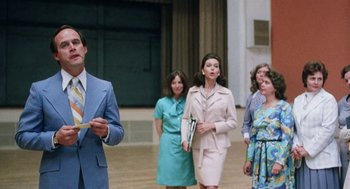 Movie still from “Smile” (1975), directed by Michael Ritchie – A group of people walking around a building; Medium shot, Low angle