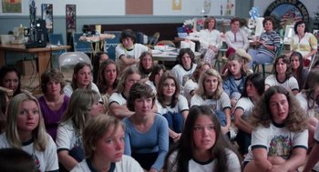 Movie still from “Smile” (1975), directed by Michael Ritchie – A large group of people sitting in a room; Wide shot, High angle