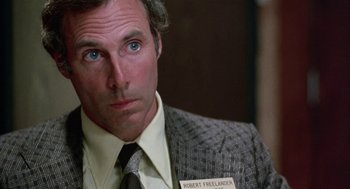 Movie still from “Smile” (1975), directed by Michael Ritchie – A person wearing a suit and tie; Close Up shot, Over the shoulder angle