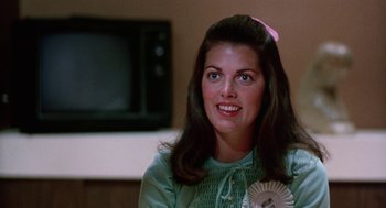 Movie still from “Smile” (1975), directed by Michael Ritchie – A person wearing a green shirt; Close Up shot, Over the shoulder angle