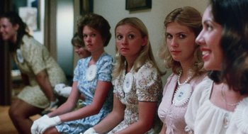 Movie still from “Smile” (1975), directed by Michael Ritchie – A group of women sitting next to each other in dresses; Medium shot, Low angle