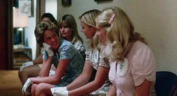 Movie still from “Smile” (1975), directed by Michael Ritchie – A group of women sitting next to each other on the floor; Medium shot, Over the shoulder angle