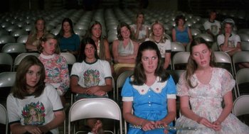Movie still from “Smile” (1975), directed by Michael Ritchie – A group of people sitting in a row in a theater; Wide shot, High angle