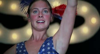 Movie still from “Smile” (1975), directed by Michael Ritchie – A person holding a feather in the air; Close Up shot, Low angle