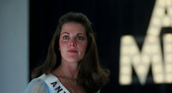 Movie still from “Smile” (1975), directed by Michael Ritchie – A woman in a blue dress is looking at the camera; Close Up shot, Low angle