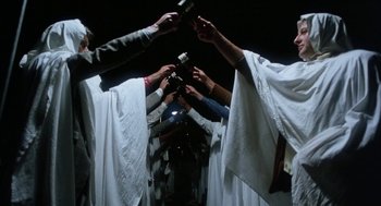 Movie still from “Smile” (1975), directed by Michael Ritchie – A group of people holding microphones in their hands; Medium shot, Low angle
