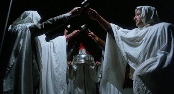 Movie still from “Smile” (1975), directed by Michael Ritchie – A group of people holding a silver tray and a cake; Medium shot, Low angle
