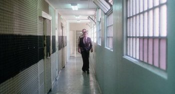 Movie still from “Smile” (1975), directed by Michael Ritchie – A man walking down a hallway in a jail cell; Wide shot, Low angle