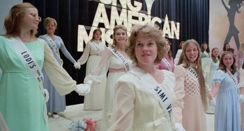 Movie still from “Smile” (1975), directed by Michael Ritchie – A group of women dressed in white and holding hands; Medium shot, Low angle