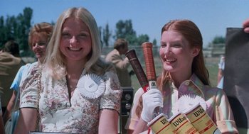 Movie still from “Smile” (1975), directed by Michael Ritchie – Two young women are posing for a picture; Close Up shot, Low angle
