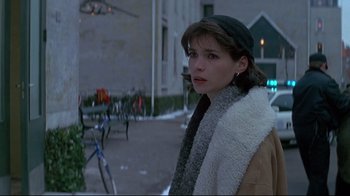 Movie still from “Smilla's Sense of Snow” (1997), directed by Bille August – A woman standing on the sidewalk in the snow; Close Up shot, Over the shoulder angle