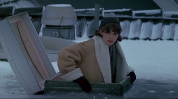 Movie still from “Smilla's Sense of Snow” (1997), directed by Bille August – A woman sitting in an ice chest in the middle of the snow; Medium shot, High angle