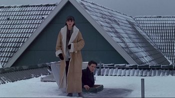 Movie still from “Smilla's Sense of Snow” (1997), directed by Bille August – A man and a woman standing in the snow next to each other; Wide shot, Low angle