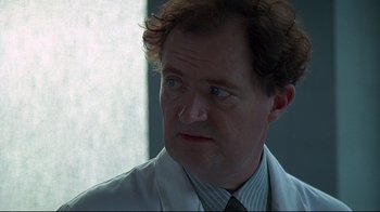 Movie still from “Smilla's Sense of Snow” (1997), directed by Bille August – A person wearing a white shirt and a tie; Close Up shot, Low angle