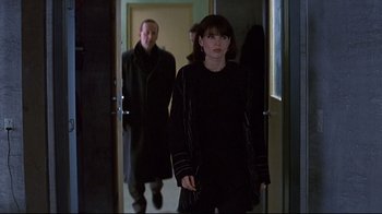 Movie still from “Smilla's Sense of Snow” (1997), directed by Bille August – A woman and a man are walking through a hallway; Medium shot, Over the shoulder angle