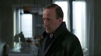 Movie still from “Smilla's Sense of Snow” (1997), directed by Bille August – A person wearing a suit and tie; Close Up shot, Low angle