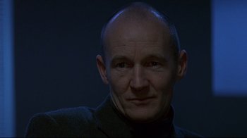 Movie still from “Smilla's Sense of Snow” (1997), directed by Bille August – A man with a bald head is looking at the camera; Close Up shot, Low angle