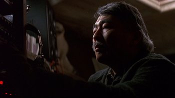 Movie still from “Smilla's Sense of Snow” (1997), directed by Bille August – A man sitting in a dark room looking up; Close Up shot, Low angle
