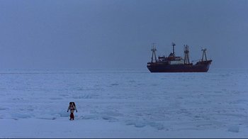 Movie still from “Smilla's Sense of Snow” (1997), directed by Bille August – A person standing in the middle of the ocean near a ship; Extreme Wide shot, High angle