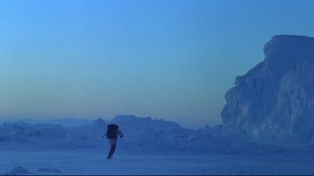 Movie still from “Smilla's Sense of Snow” (1997), directed by Bille August – A person walking in the snow with a backpack; Extreme Wide shot, Low angle