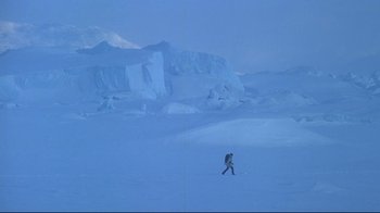 Movie still from “Smilla's Sense of Snow” (1997), directed by Bille August – A man walking across a snow covered field; Extreme Wide shot, High angle