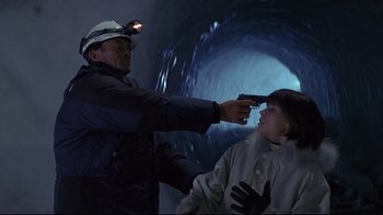 Movie still from “Smilla's Sense of Snow” (1997), directed by Bille August – A man and a woman in a cave with lights on their heads; Medium shot, High angle
