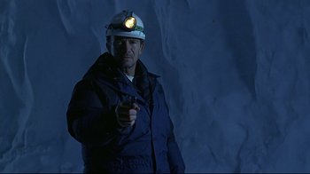 Movie still from “Smilla's Sense of Snow” (1997), directed by Bille August – A man wearing a hard hat pointing at the camera; Medium shot, Low angle