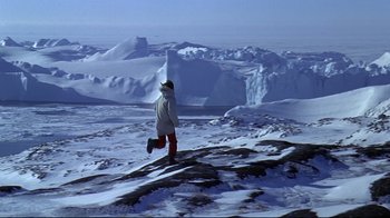 Movie still from “Smilla's Sense of Snow” (1997), directed by Bille August – A man is running on a snowy hill; Extreme Wide shot, High angle
