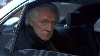 Movie still from “Smilla's Sense of Snow” (1997), directed by Bille August – An older man sitting in a car looking out the window; Close Up shot, High angle