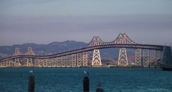 Movie still from “Smooth Talk” (1985), directed by Joyce Chopra – A view of a bridge that is in the water; Extreme Wide shot, Low angle