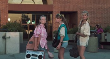 Movie still from “Smooth Talk” (1985), directed by Joyce Chopra – A group of young women standing next to each other on a sidewalk; Wide shot, Low angle