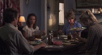 Movie still from “Smooth Talk” (1985), directed by Joyce Chopra – A group of people sitting around a table eating; Medium shot, Over the shoulder angle