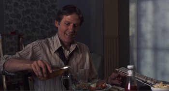 Movie still from “Smooth Talk” (1985), directed by Joyce Chopra – A man sitting at a table with a plate of food; Medium shot, Over the shoulder angle