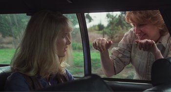 Movie still from “Smooth Talk” (1985), directed by Joyce Chopra – A woman looking out the window of a car at another woman; Close Up shot, Over the shoulder angle