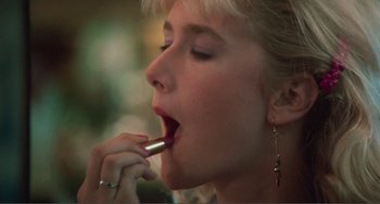 Movie still from “Smooth Talk” (1985), directed by Joyce Chopra – A woman is putting lipstick in her mouth; Close Up shot, Over the shoulder angle
