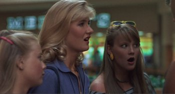 Movie still from “Smooth Talk” (1985), directed by Joyce Chopra – Two women standing next to each other and one of the women has her mouth open; Close Up shot, Over the shoulder angle