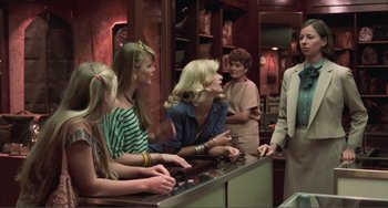 Movie still from “Smooth Talk” (1985), directed by Joyce Chopra – A group of people standing at a counter; Medium shot, Over the shoulder angle