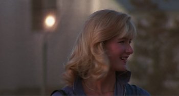 Movie still from “Smooth Talk” (1985), directed by Joyce Chopra – A woman with blonde hair smiling at the camera; Close Up shot, Over the shoulder angle