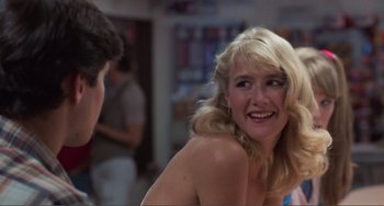 Movie still from “Smooth Talk” (1985), directed by Joyce Chopra – A woman with blonde hair and a blue dress is talking to a man in front of him; Close Up shot, Over the shoulder angle
