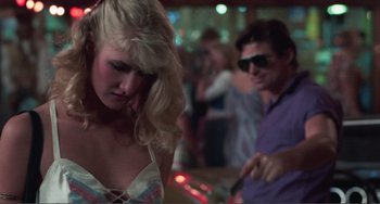 Movie still from “Smooth Talk” (1985), directed by Joyce Chopra – A man and a woman in front of a crowd of onlookers; Medium shot, Over the shoulder angle