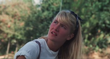 Movie still from “Smooth Talk” (1985), directed by Joyce Chopra – A young blonde haired woman wearing a white shirt; Close Up shot, Low angle