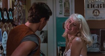 Movie still from “Smooth Talk” (1985), directed by Joyce Chopra – A young man standing next to a young blonde woman; Medium shot, Over the shoulder angle
