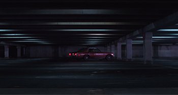 Movie still from “Smooth Talk” (1985), directed by Joyce Chopra – A red car parked in a parking garage at night; Extreme Wide shot, High angle